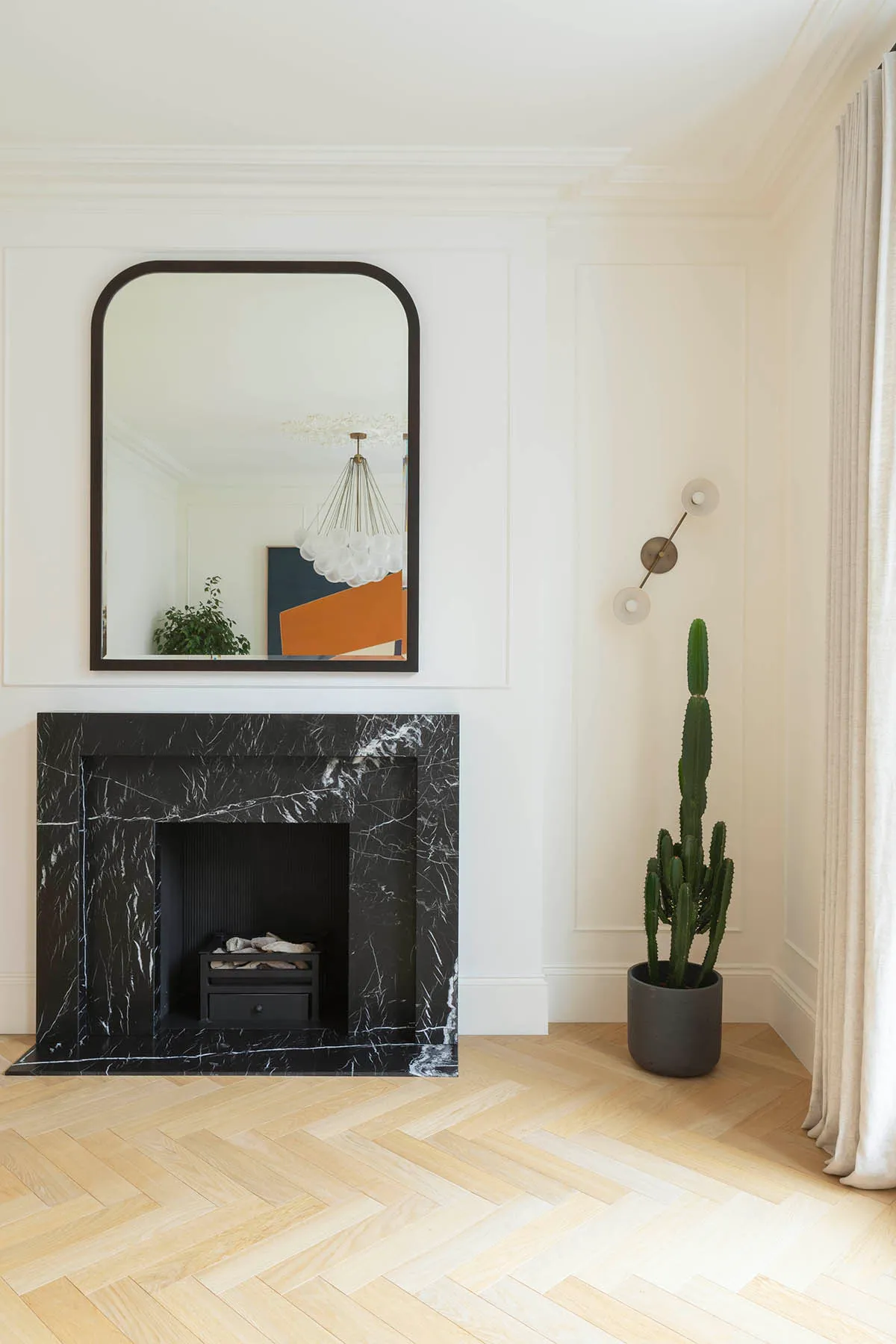 Marble fireplace and herringbone floor in the reception