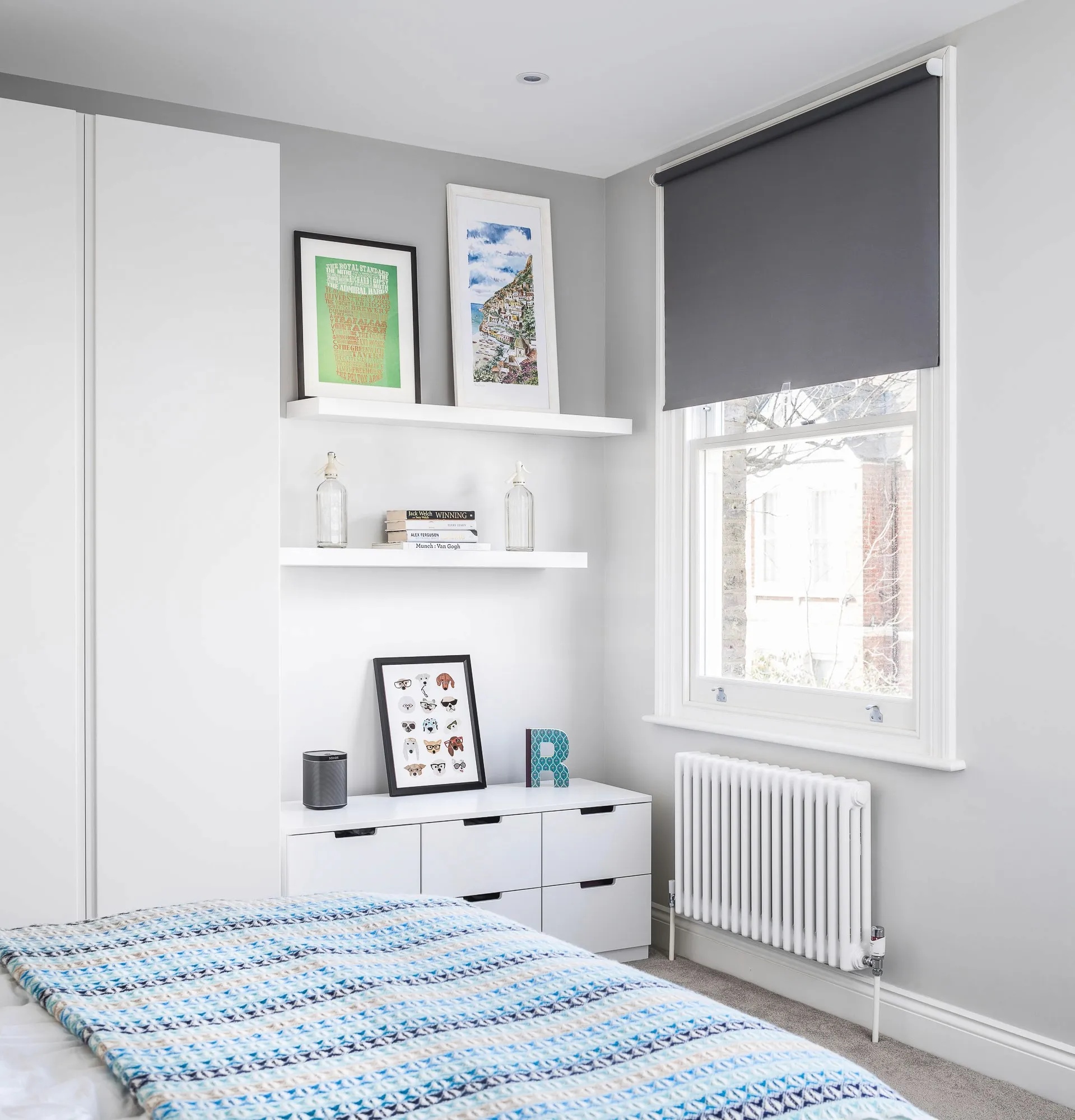 Loft bedroom with fitted wardrobes and shelving