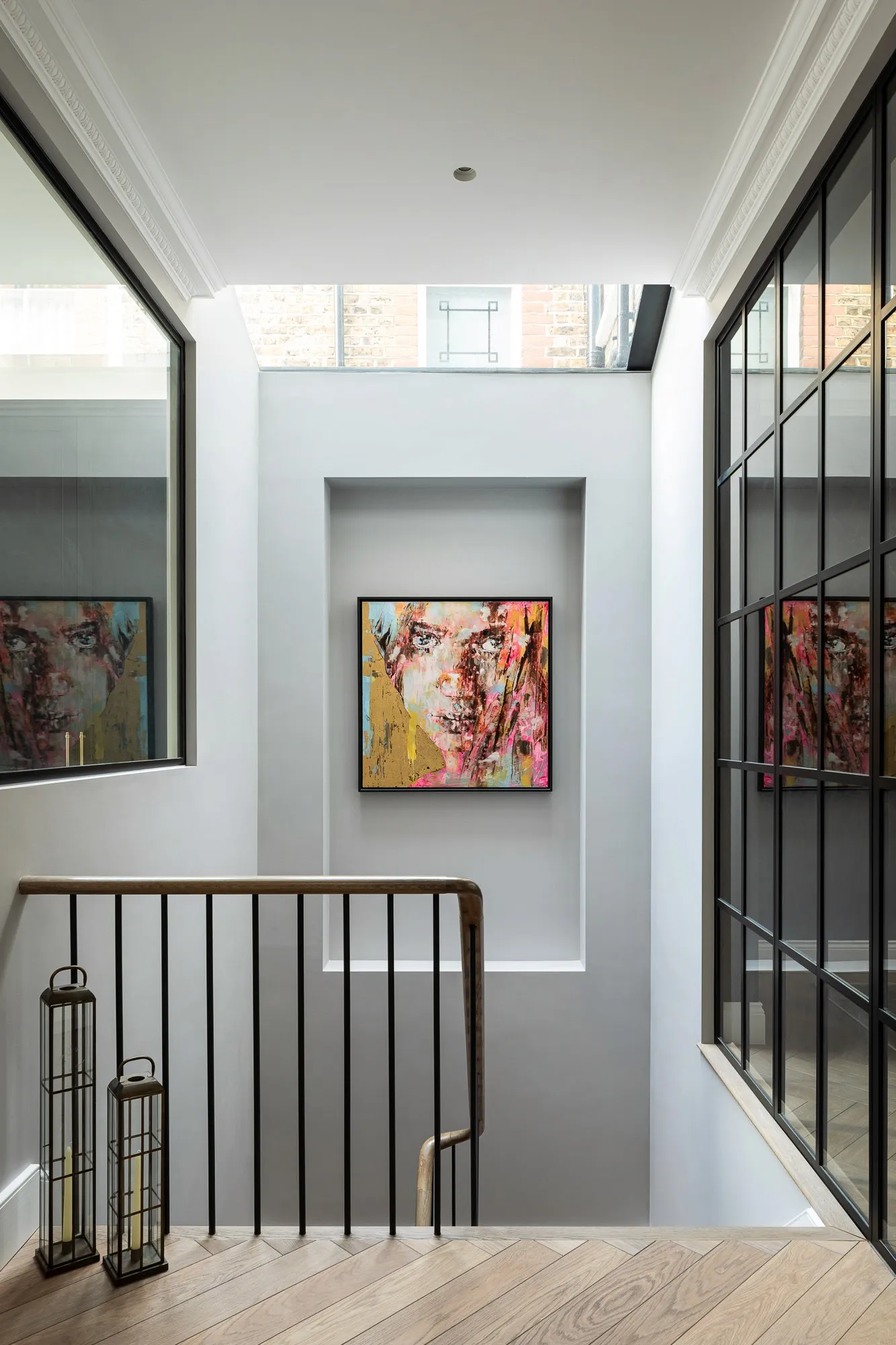 Brass handrail and artwork on the basement stair