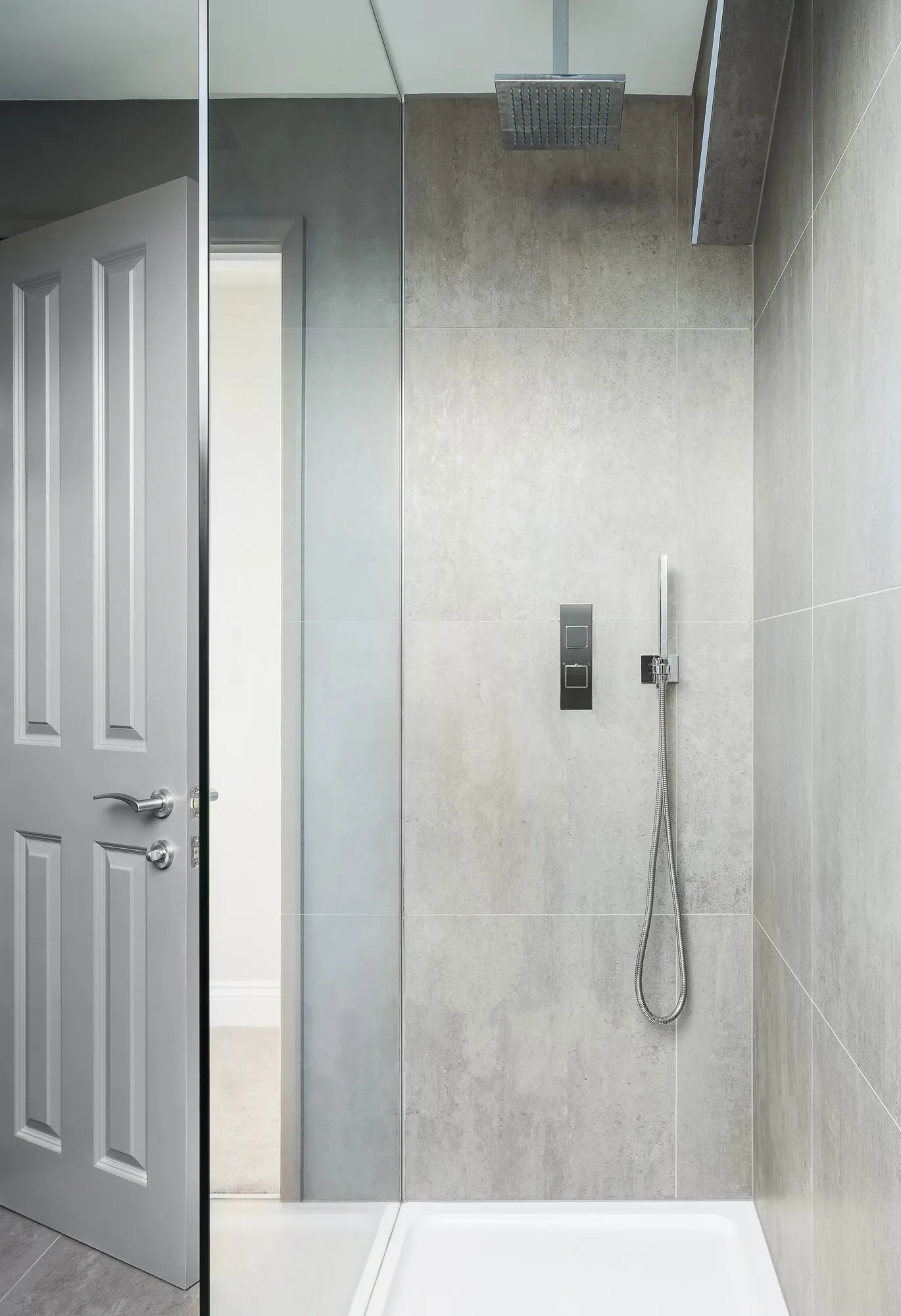 Walk-in shower behind a panelled door