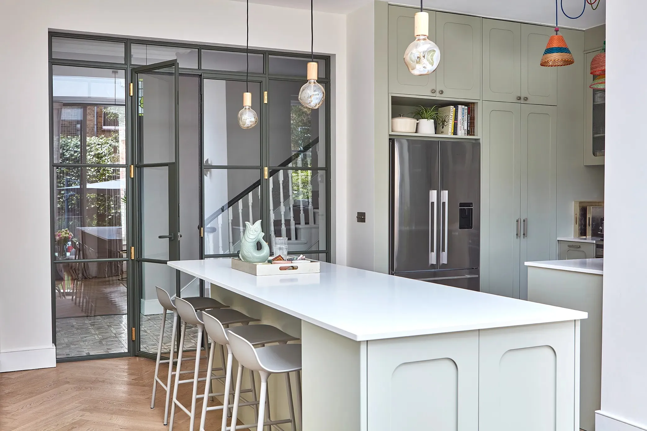 Island and stools beside the steel-framed screen