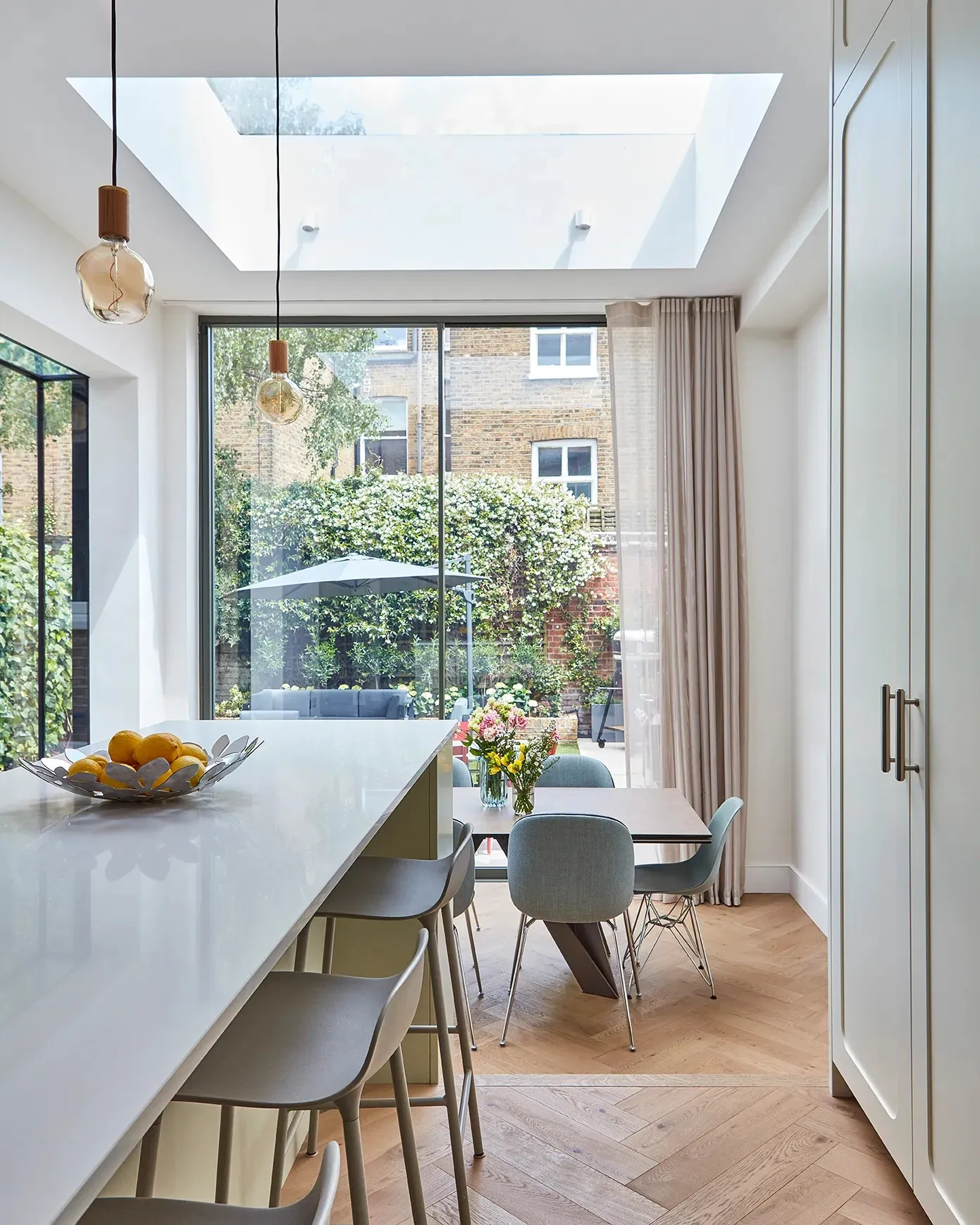 Dining table under the rooflight and garden doors