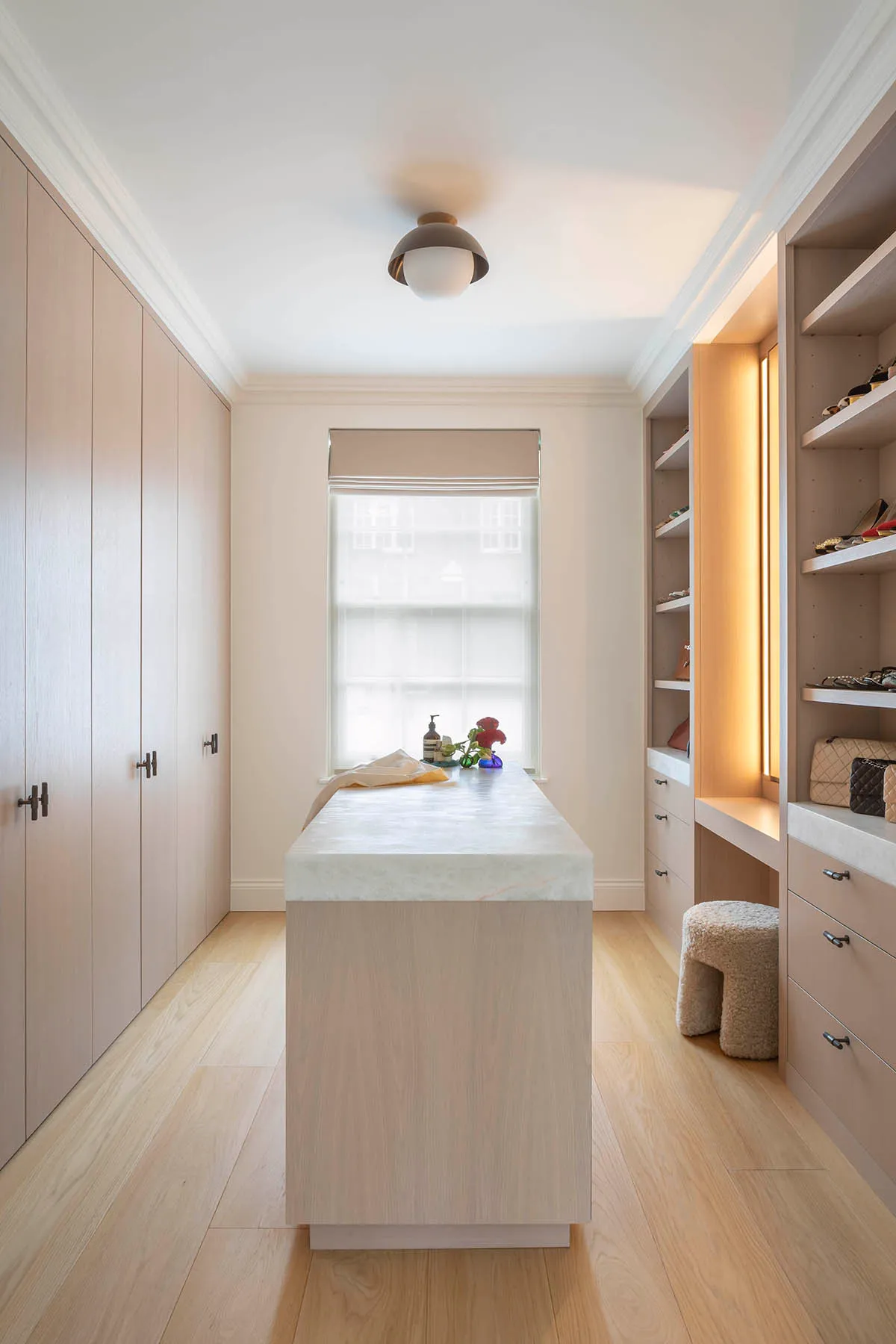 Dressing room island between fitted wardrobes