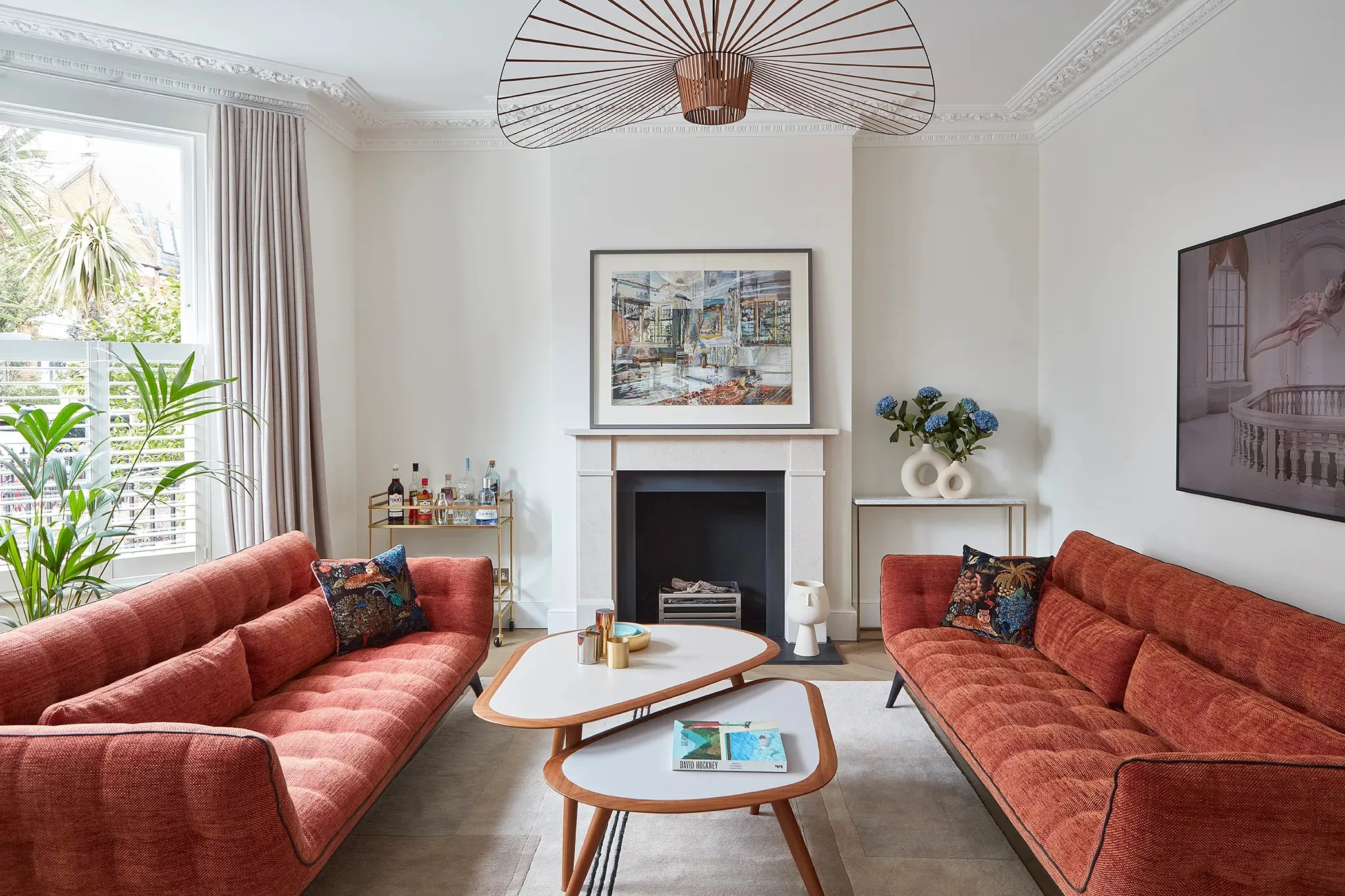Front living room with fireplace and red sofas
