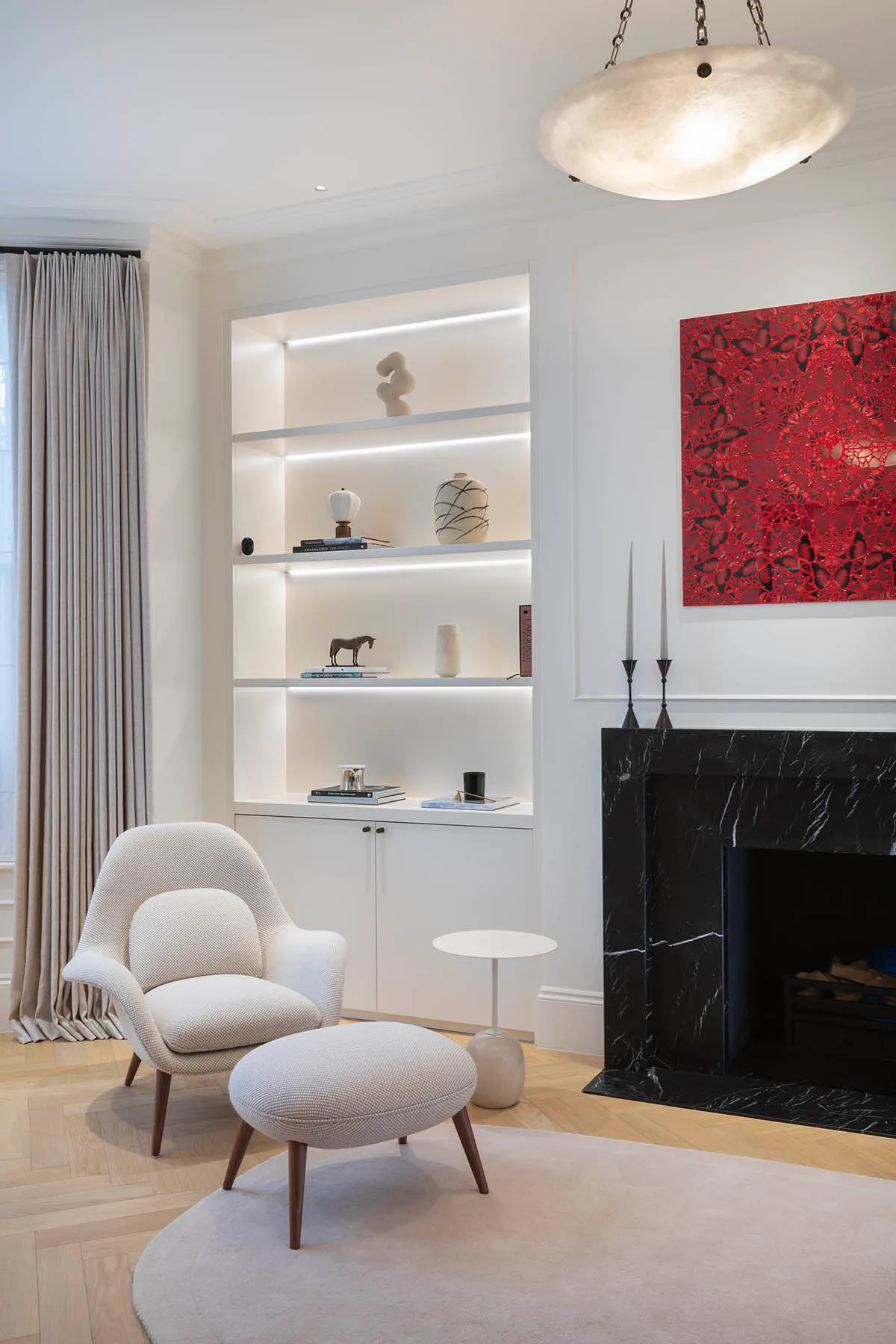 Drawing room chair beside the lit alcoves
