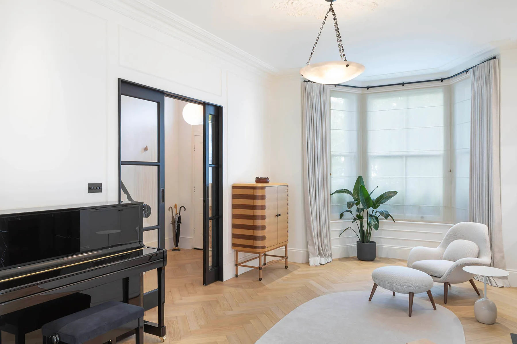 Upright piano beside the glazed black door