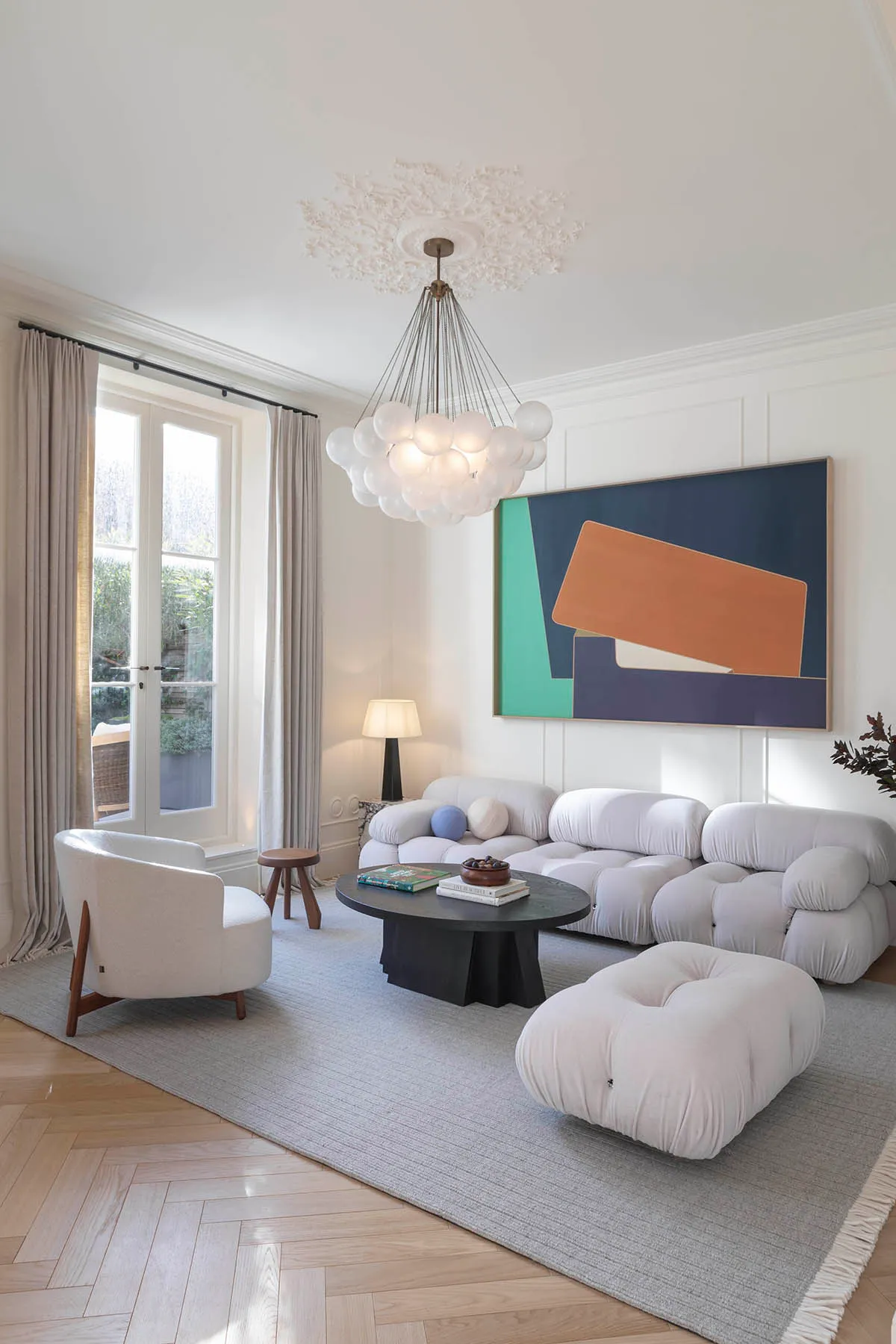 Modular sofa below a large abstract painting
