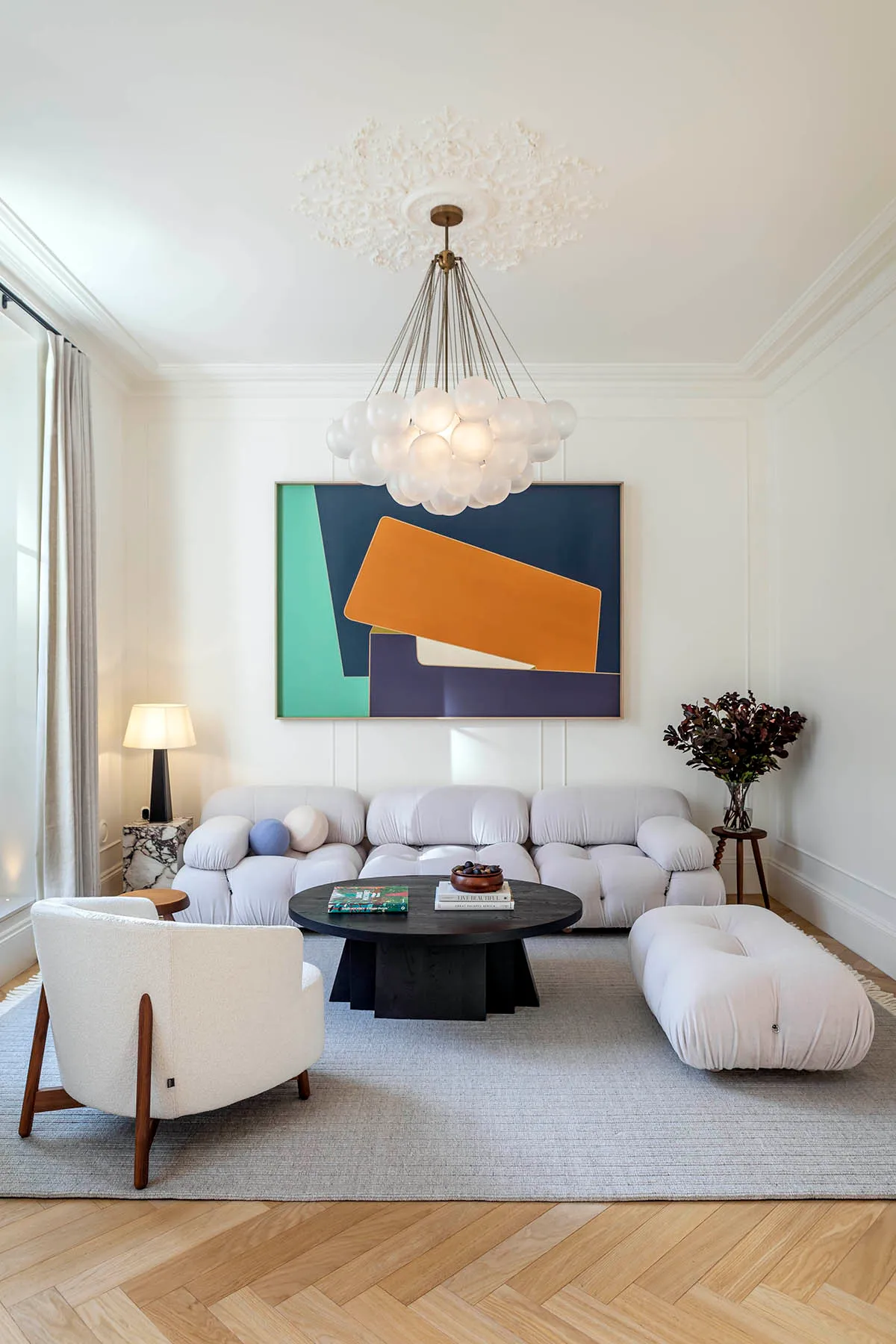 Sitting room seating and glass-globe chandelier