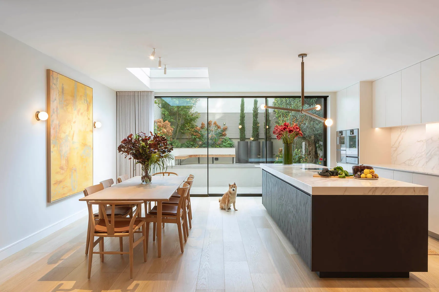 Kitchen island and dining table under the rooflight