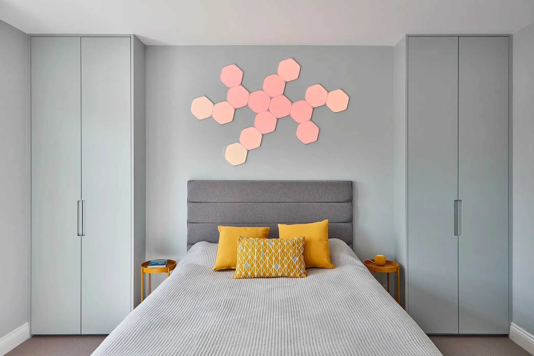 Bedroom flanked by full-height fitted wardrobes
