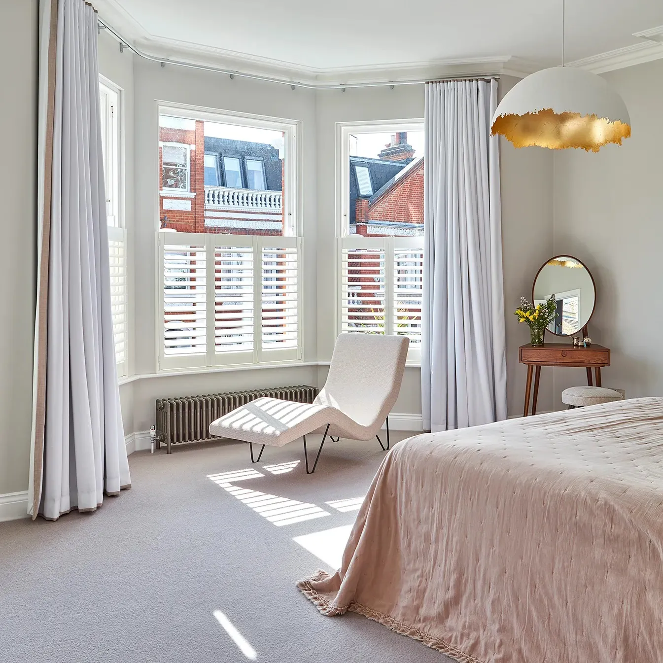 Principal bedroom bay with shutters and curtains