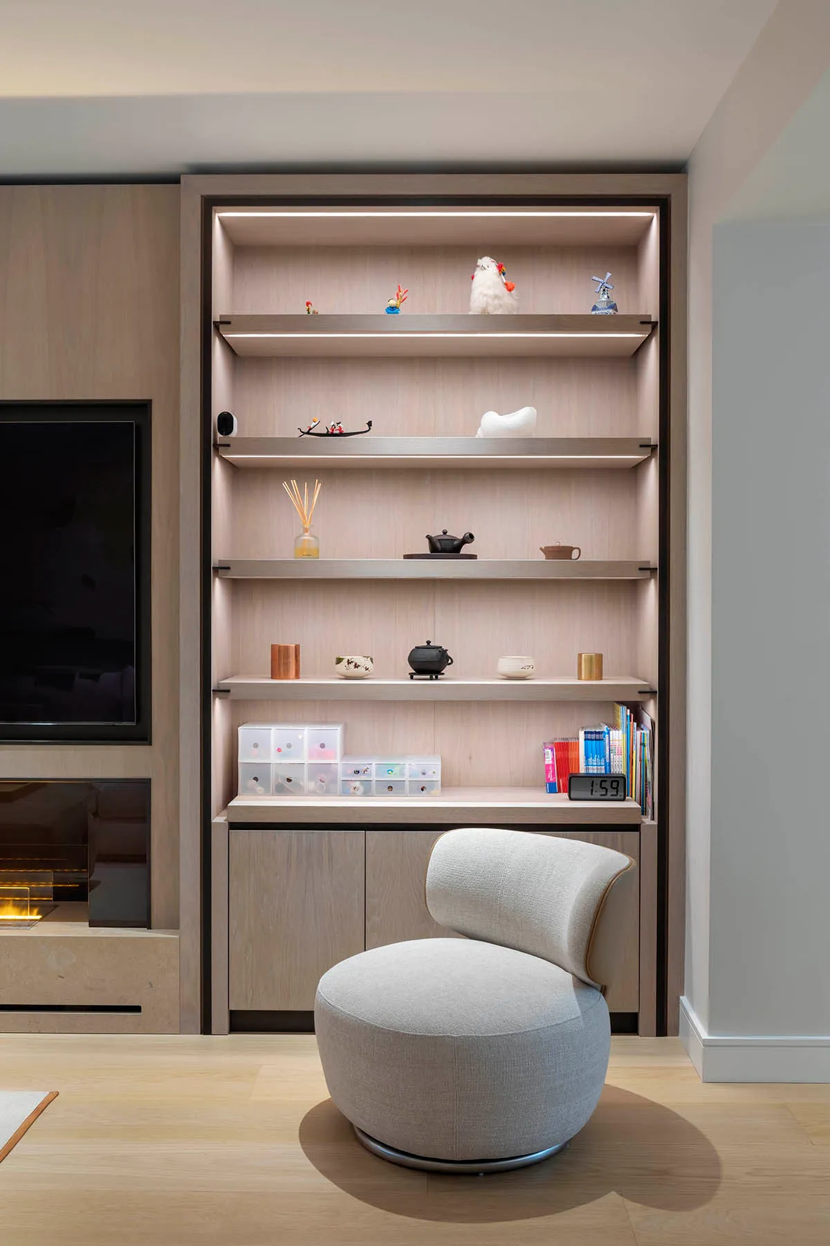 Lit oak display shelves beside the television