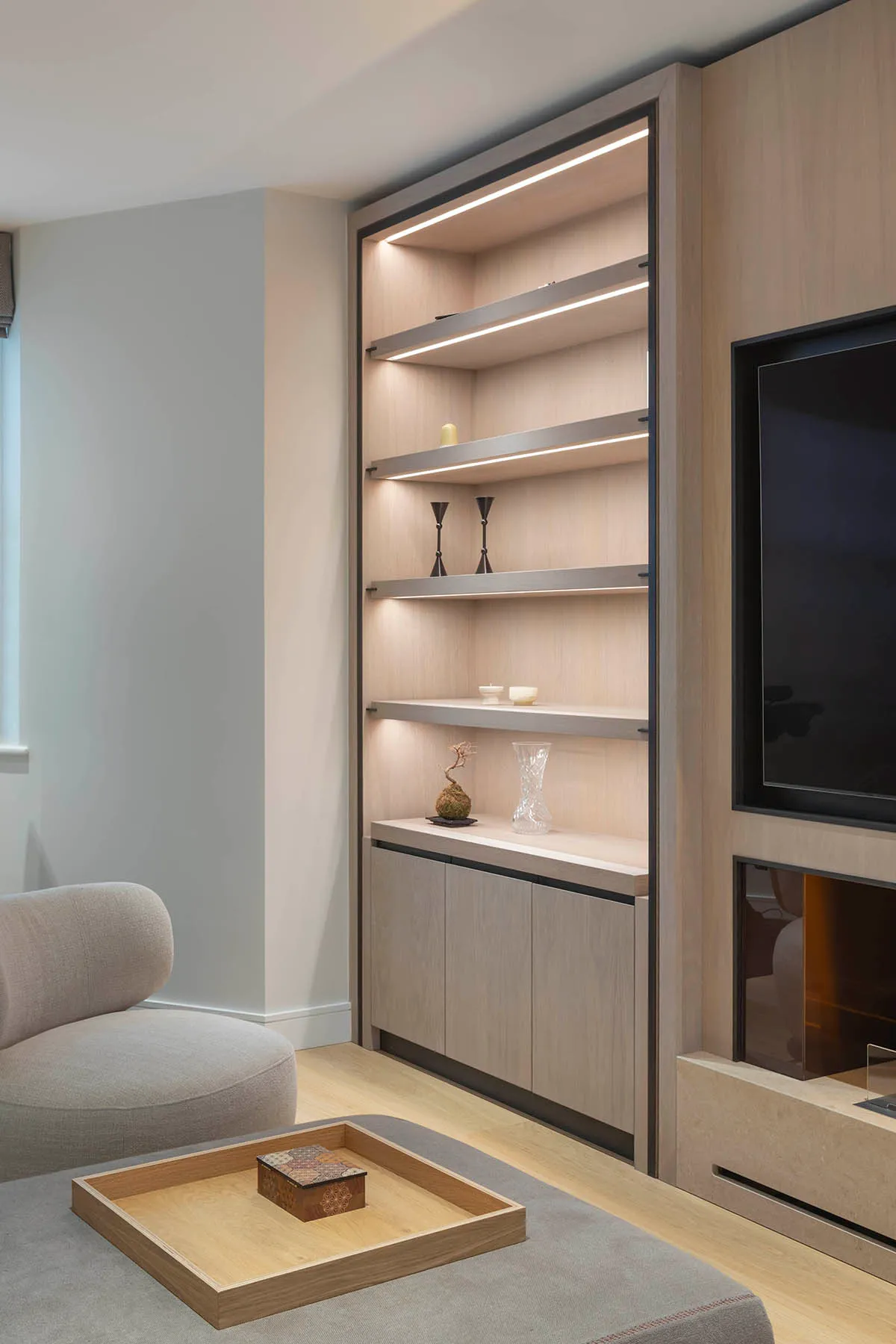 Oak media wall with lit shelving