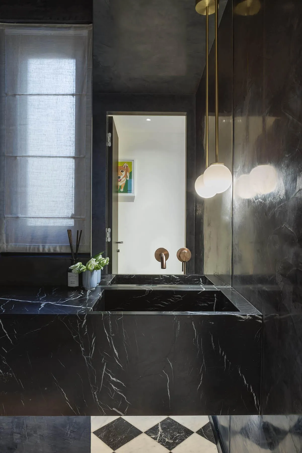 Black marble bath with brass fittings