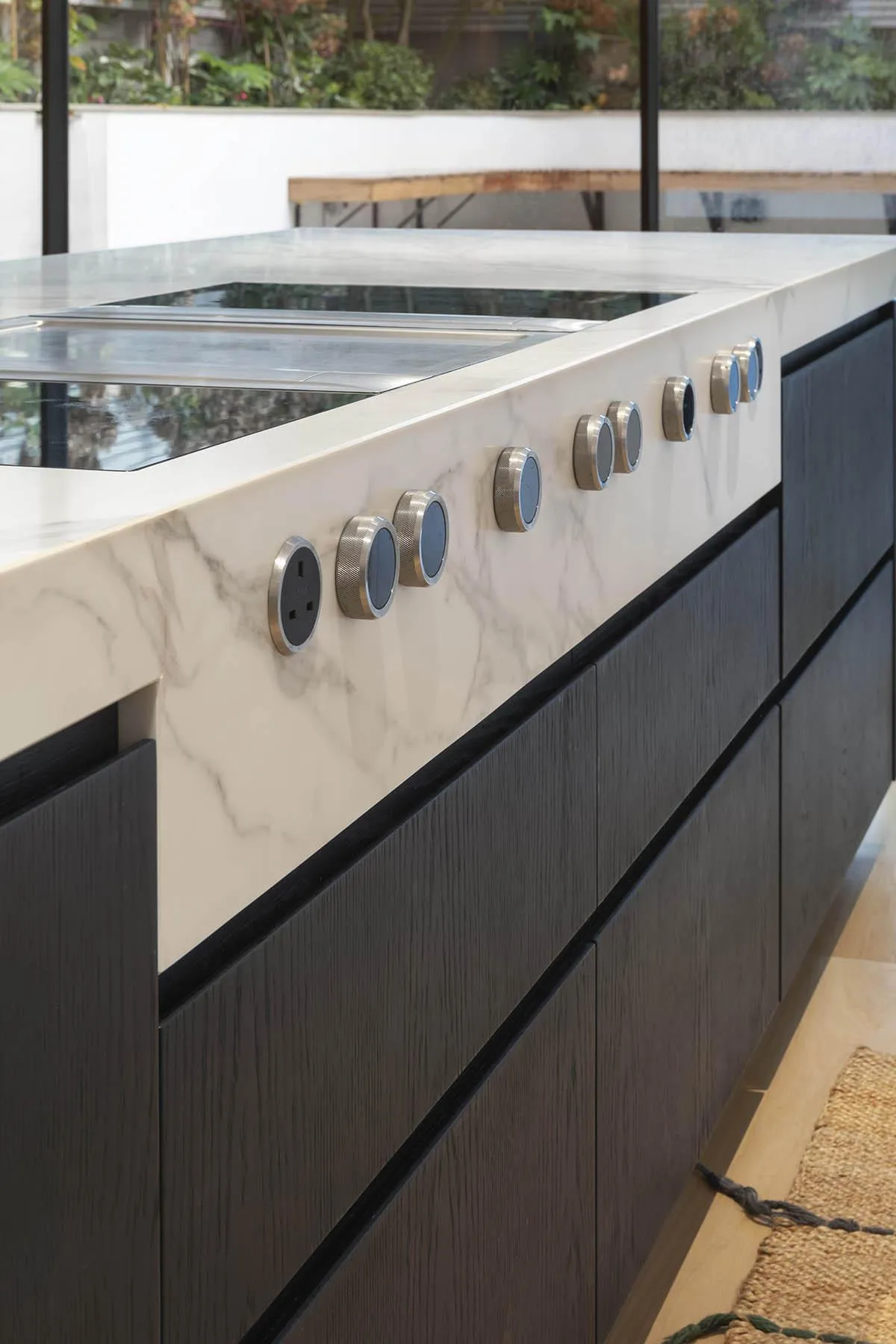 Marble island edge above dark joinery