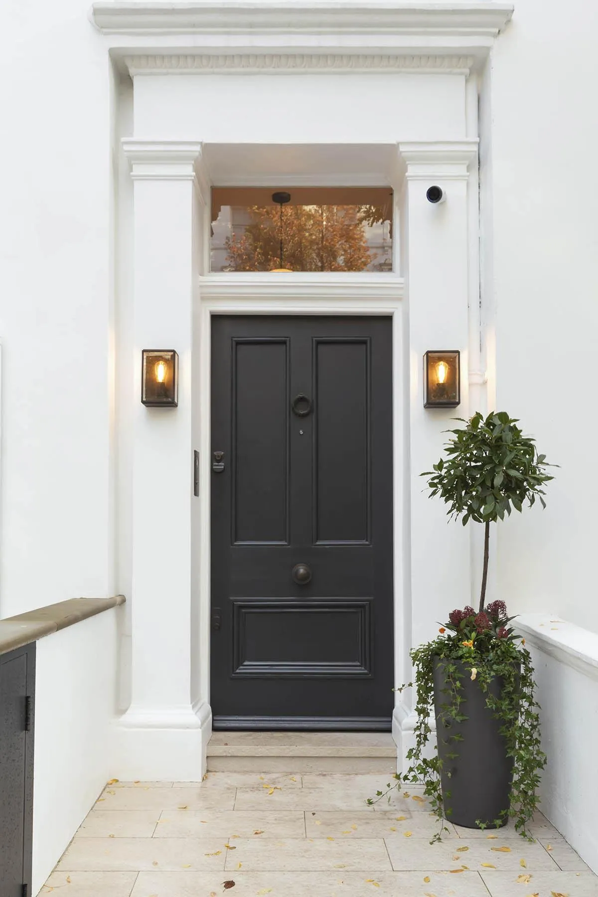 Black front door under white stucco